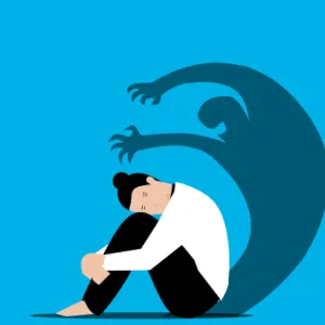 individu recroquevillé avec ombre derrière lui symbolisant anxiété et conscience de soi